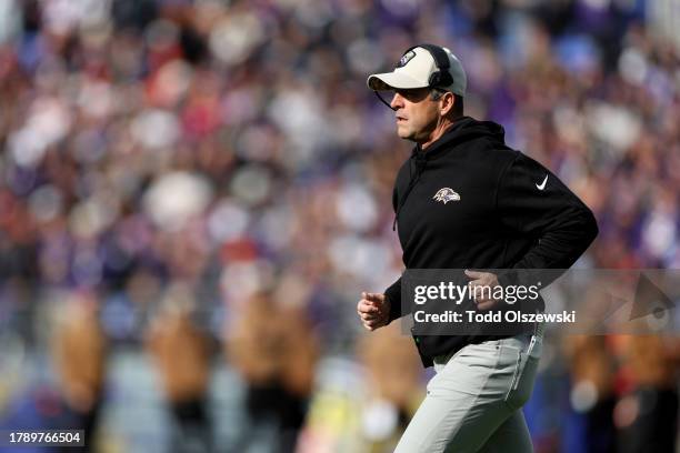 Head coach John Harbaugh of the Baltimore Ravens runs off the field against the Cleveland Browns during the first quarter at M&T Bank Stadium on...