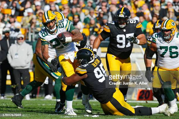 Keeanu Benton of the Pittsburgh Steelers tackles AJ Dillon of the Green Bay Packers during the first quarter at Acrisure Stadium on November 12, 2023...