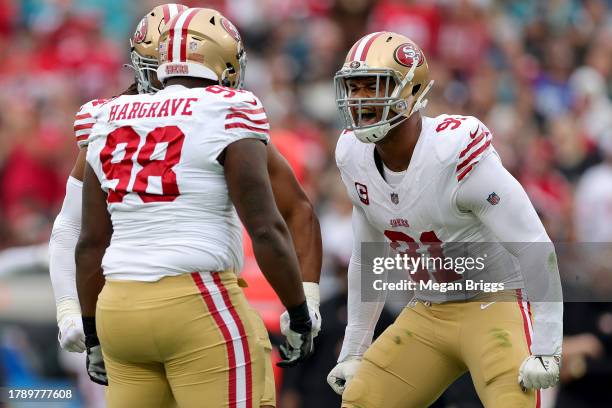 Arik Armstead of the San Francisco 49ers celebrates a sack by Javon Hargrave of the San Francisco 49ers during the first quarter against the...