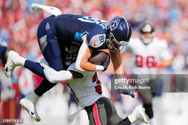 Antoine Winfield Jr. #31 of the Tampa Bay Buccaneers tackles Josh Whyle of the Tennessee Titans during the first quarter at Raymond James Stadium on...