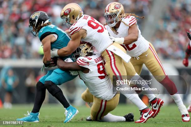 Trevor Lawrence of the Jacksonville Jaguars is sacked by Javon Hargrave of the San Francisco 49ers during the first quarter at EverBank Stadium on...