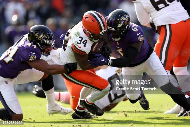 Jerome Ford of the Cleveland Browns is tackled by Marlon Humphrey of the Baltimore Ravens and Patrick Queen during the first quarter at M&T Bank...