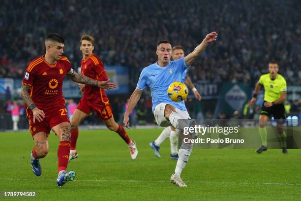 Adam Marusic of SS Lazio controls the ball in the air under pressure from Gianluca Mancini of AS Roma during the Serie A TIM match between SS Lazio...