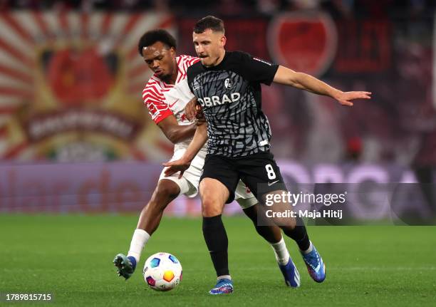 Maximilian Eggestein of Sport-Club Freiburg is challenged by Lois Openda of RB Leipzig during the Bundesliga match between RB Leipzig and Sport-Club...