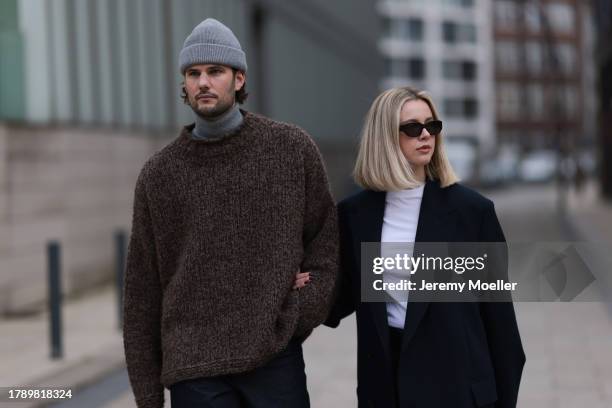 Felix Hartmann seen wearing Acne Studios grey beanie / hat, Allude grey cashmere turtleneck, by Aylin Koenig brown wool knit sweater, COS dark blue...