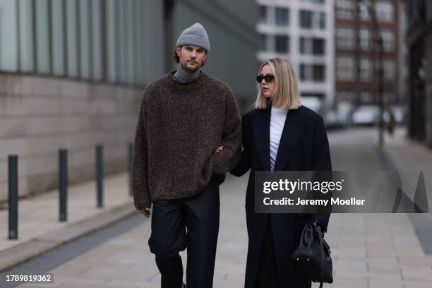 Felix Hartmann seen wearing Acne Studios grey beanie / hat, Allude grey cashmere turtleneck, by Aylin Koenig brown wool knit sweater, COS dark blue...