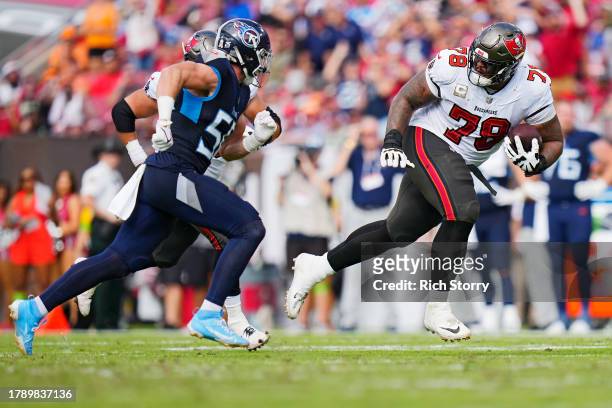 Tristan Wirfs of the Tampa Bay Buccaneers runs the ball after recovering a fumble during the second quarter against the Tennessee Titans at Raymond...