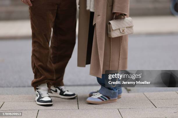 Felix Hartmann seen wearing Carhartt brown cord pants and Nike Air Jordan 1 high dark mokka sneakers; Isabelle Hartmann seen wearing vintage blue...