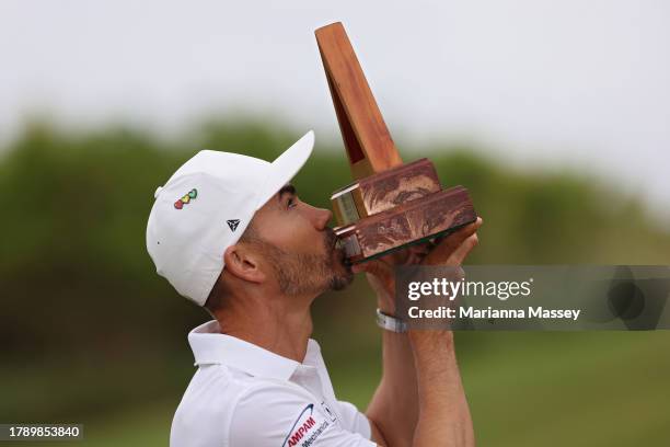 Camilo Villegas of Colombia celebrates kisses the trophy after winning the Butterfield Bermuda Championship at Port Royal Golf Course on November 12,...