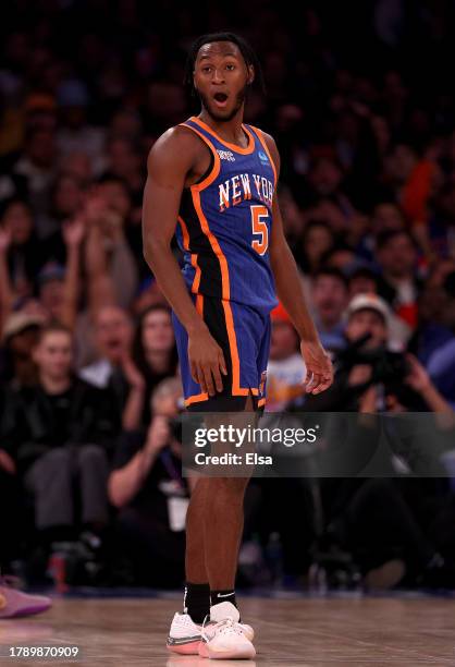 Immanuel Quickley of the New York Knicks reacts after his three point shot and he drew the foul against the Charlotte Hornets during the second half...