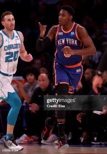 Barrett of the New York Knicks celebrates his three point shot as Gordon Hayward of the Charlotte Hornets looks on during the second half at Madison...