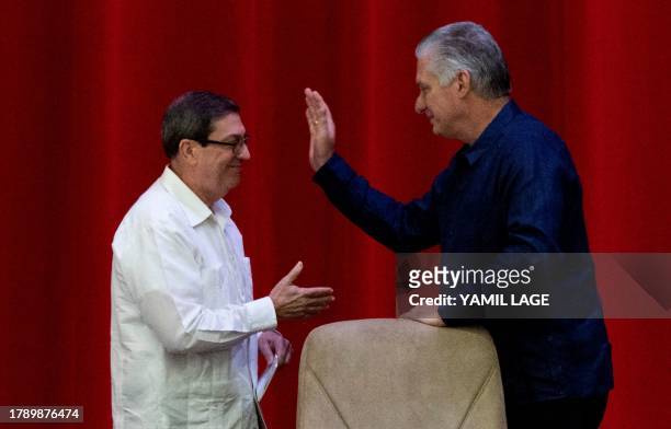 Cuban president Miguel Díaz Canel and Foreign Minister Bruno Rodríguez shake hands during the inauguration of the IV Nation and Emigration...