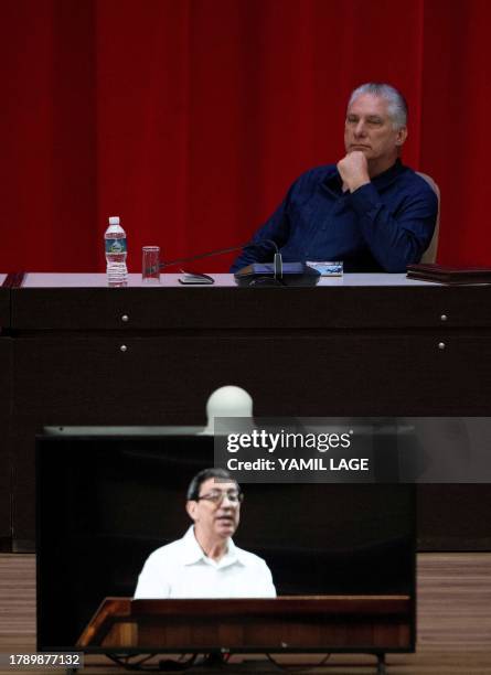 Cuban president Miguel Díaz Canel listens to Foreign Minister Bruno Rodríguez during the inauguration of the IV Nation and Emigration Conference, at...