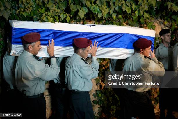 Soldiers carry the coffin of school principal and Sgt. Maj. Yossi Hershkovitz, aged 44, who was killed in Northern Gaza, during his funeral service...