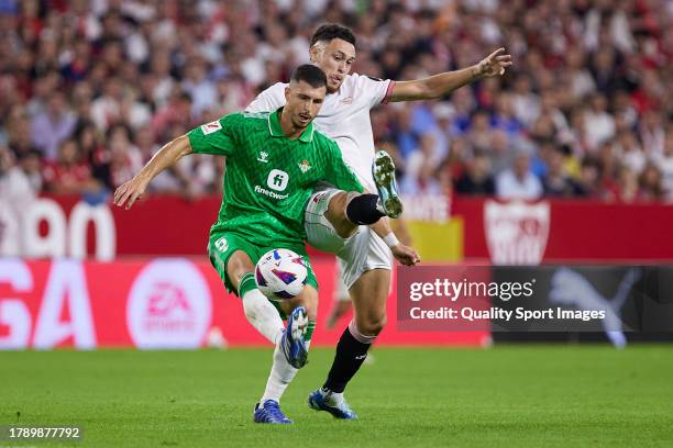 Lucas Ocampos of Sevilla FC competes for the ball with Guido Rodriguez of Real Betis during the LaLiga EA Sports match between Sevilla FC and Real...