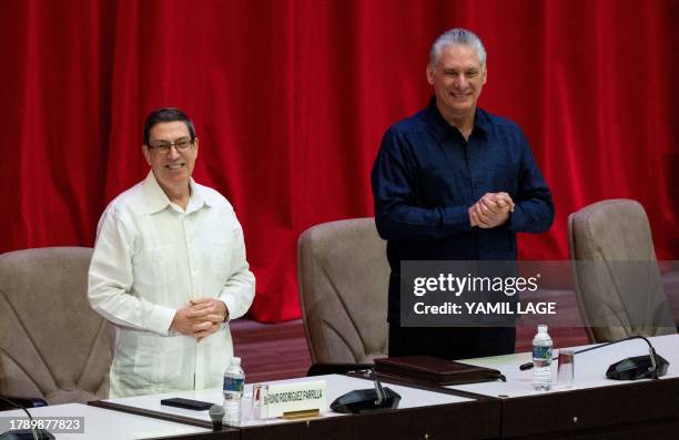 Cuban president Miguel Díaz Canel and Foreign Minister Bruno Rodríguez gesture during the inauguration of the IV Nation and Emigration Conference, at...