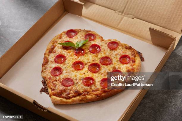 heart shaped pepperoni pizza - heart shape pizza stock pictures, royalty-free photos & images