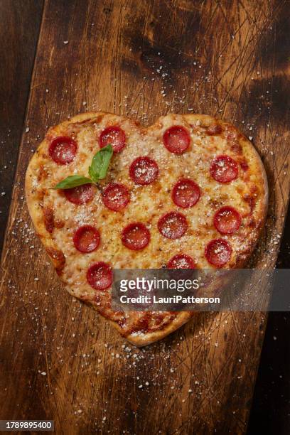 heart shaped pepperoni pizza - heart shape pizza stock pictures, royalty-free photos & images