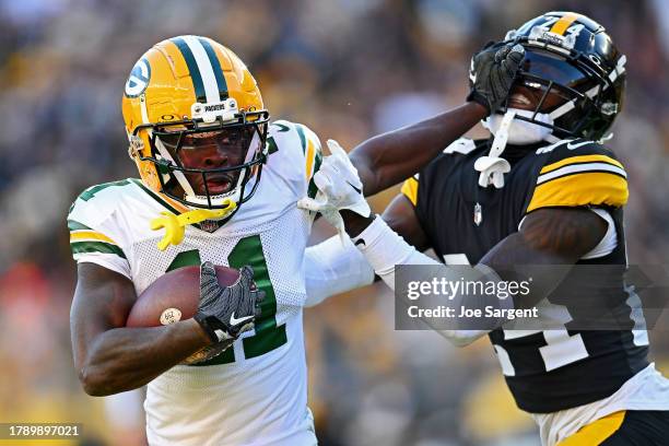 Jayden Reed of the Green Bay Packers stiff arms Joey Porter Jr. #24 of the Pittsburgh Steelers during the third quarter at Acrisure Stadium on...