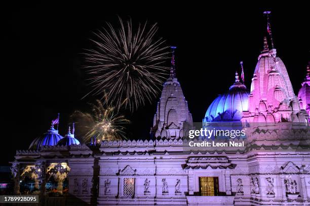 Fireworks explode in the sky above the domed architecture of Neasden Temple, also known as BAPS Shri Swaminarayan Mandir, during Diwali celebrations...