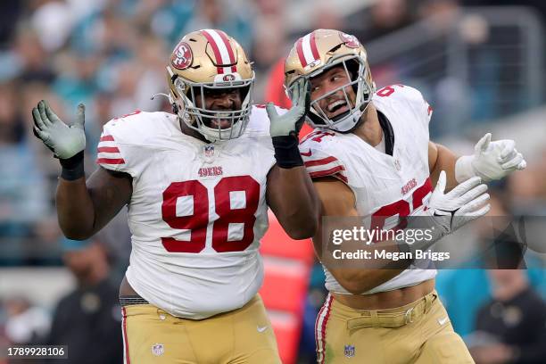 Nick Bosa of the San Francisco 49ers celebrates a sack with Javon Hargrave of the San Francisco 49ers during the third quarter against the...