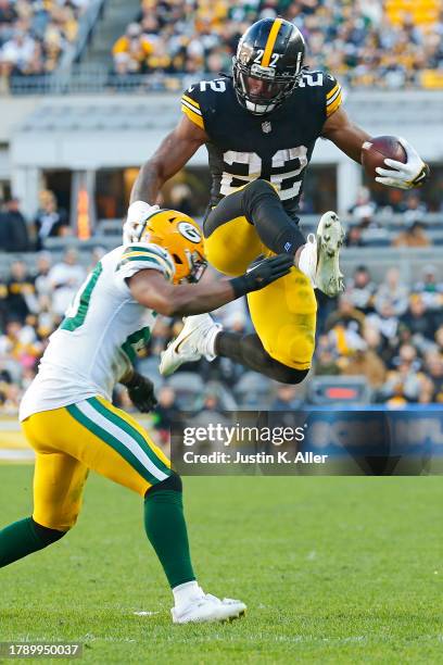 Najee Harris of the Pittsburgh Steelers hurdles Rudy Ford of the Green Bay Packers during the fourth quarter at Acrisure Stadium on November 12, 2023...