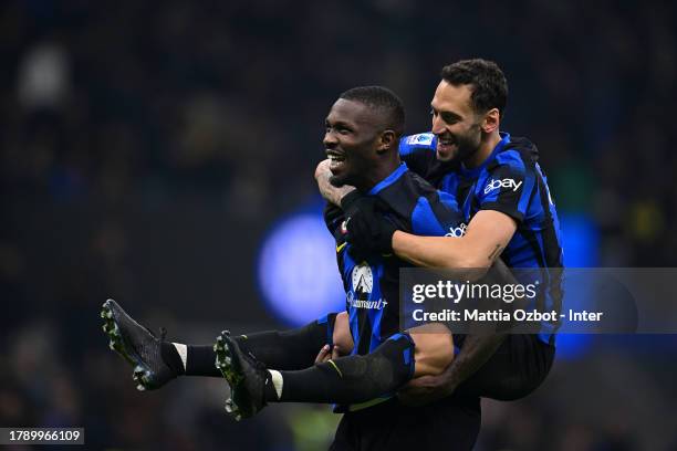 Hakan Çalhanoğlu of FC Internazionale celebrates with Marcus Thuram after scoring their team's second goal during the Serie A TIM match between FC...