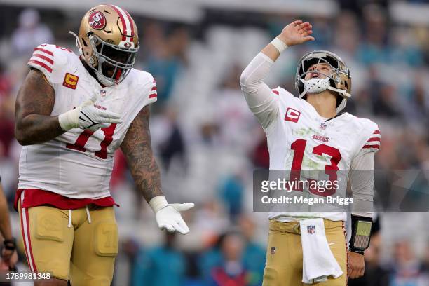 Brock Purdy of the San Francisco 49ers and Trent Williams of the San Francisco 49ers celebrate a touchdown during the fourth quarter against the...