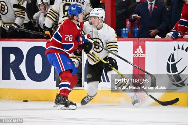 Christian Dvorak of the Montreal Canadiens defends against Mason Lohrei of the Boston Bruins during the third period against the Montreal Canadiens...