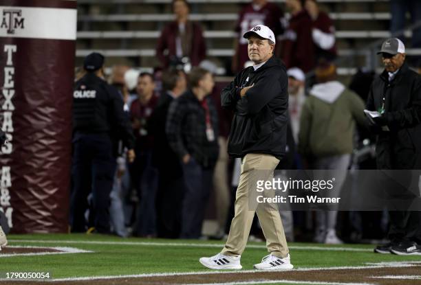 Ead coach Jimbo Fisher of the Texas A&M Aggies watches players warm up before the game against the Mississippi State Bulldogs at Kyle Field on...