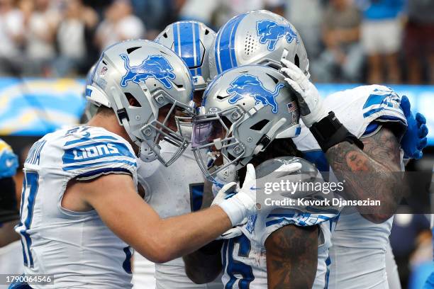 Jahmyr Gibbs of the Detroit Lions celebrates a touchdown with teammates during the first half against the Los Angeles Chargers at SoFi Stadium on...