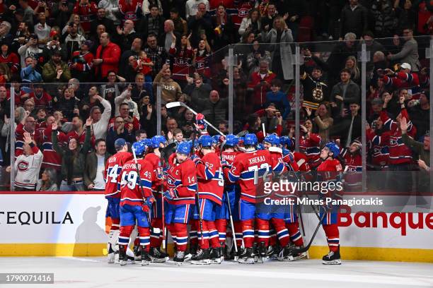 The Montreal Canadiens celebrate their overtime victory against the Boston Bruins at the Bell Centre on November 11, 2023 in Montreal, Quebec,...
