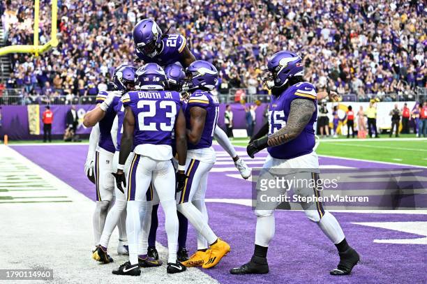 Byron Murphy Jr. #7 of the Minnesota Vikings celebrates an interception with teammates against the New Orleans Saints during the fourth quarter at...