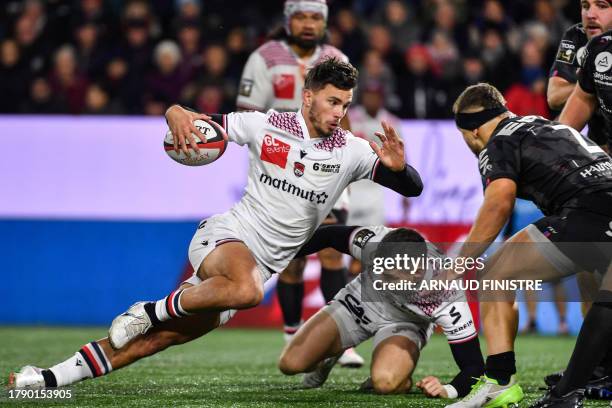 Lyon's French centre Ethan Dumortier fights for the ball Oyonnax' French hooker Teddy Durand during the French Top14 rugby union match between Union...