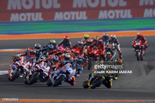 Riders compete at the start of the Tissot Sprint race ahead of the Moto GP Grand Prix of Qatar at the Lusail International Circuit on November 18,...