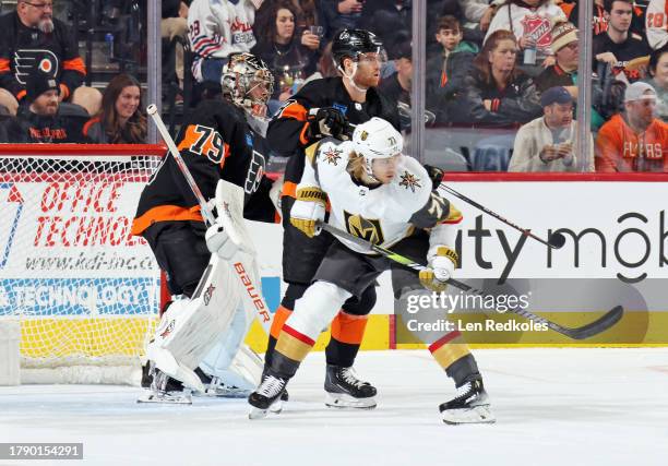 Carter Hart of the Philadelphia Flyers protects his net as teammate Cam York defends against William Karlsson of the Vegas Golden Knights at the...