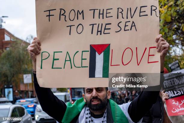 Protester holds up a placard which reads 'From the river to the sea, peace and love' following last weekends pro-Palestinian ceasefire now...