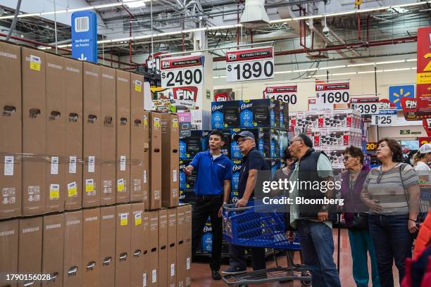 An employee assists shoppers during the Buen Fin sale at a Walmart Supercenter store in Mexico City, Mexico, on Saturday, Nov. 11, 2023. Mexico's...