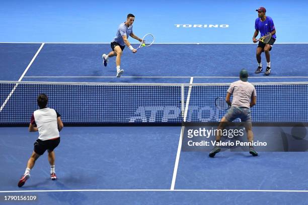Joe Salisbury of Great Britain plays a forehand with partner Rajeev Ram of United States against Edouard Roger-Vasselin of France and Santiago...