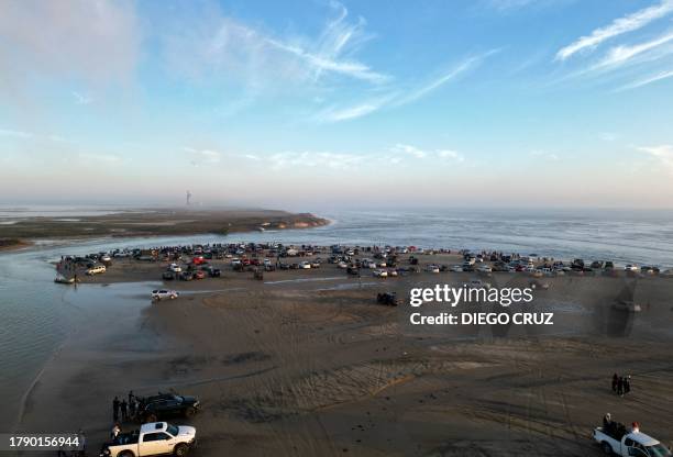 People arrive at Boca Del Río de la Playa Bagdad, in Matamoros, Tamaulipas State, Mexico, to witness the launch of SpaceX's Starship rocket -from...