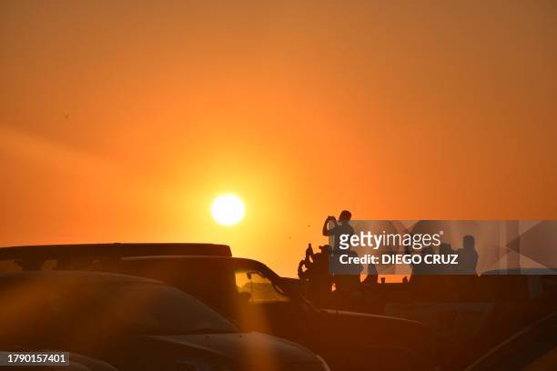 People in Boca Del Río de la Playa Bagdad, in Matamoros, Tamaulipas State, Mexico, take snapshots during the launch of SpaceX's Starship rocket -from...
