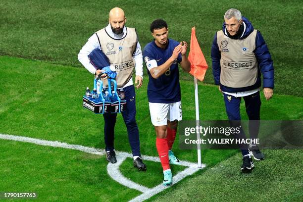 France's midfielder Warren Zaire-Emery leaves the pitch after being injured during the UEFA EURO 2024 Group B qualifying football match between...
