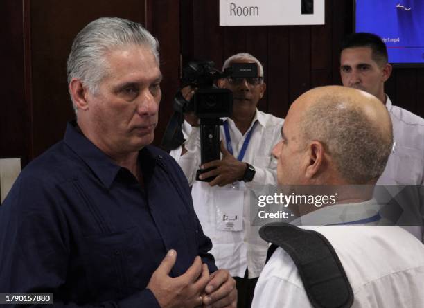 This frame grab from AFPTV video footage shows Cuban President Miguel Díaz Canel talking with a participant of the IV Nation and Emigration...