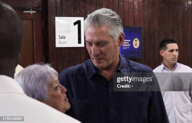 This frame grab from AFPTV video footage shows Cuban President Miguel Díaz Canel talking with a participant of the IV Nation and Emigration...