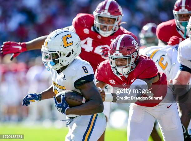 Jihaad Campbell of the Alabama Crimson Tide tackles Gino Appleberry of the Chattanooga Mocs during the second half at Bryant-Denny Stadium on...