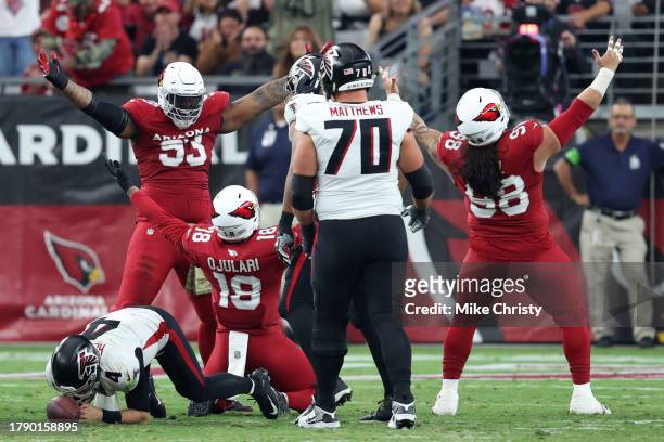 Ojulari of the Arizona Cardinals celebrates a sack against Taylor Heinicke of the Atlanta Falcons with teammates Jonathan Ledbetter and Roy Lopez...