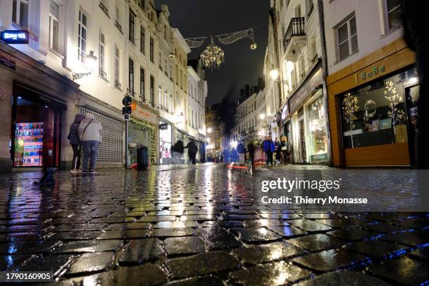 Despite the rain, tourists enjoy the nightlife in the street of the 'Îlot Sacré' on November 18, 2023 in Brussels, Belgium. In Brussels the month of...