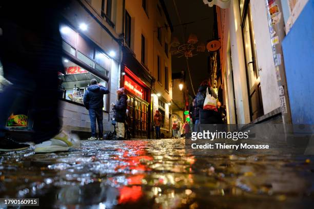 Despite the rain, tourists enjoy the nightlife in the street of the 'Îlot Sacré' on November 18, 2023 in Brussels, Belgium. In Brussels the month of...