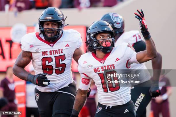 Kevin Concepcion of the NC State Wolfpack celebrates after a touchdown against the Virginia Tech Hokies in the first half during a game at Lane...