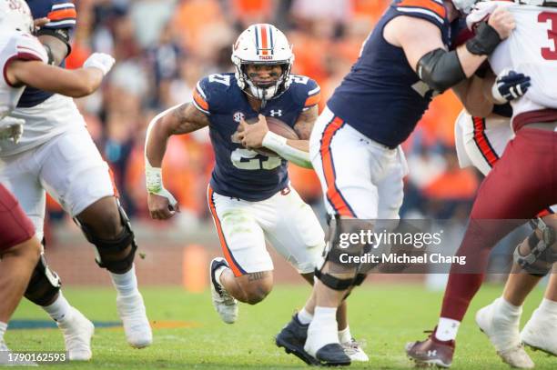 Running back Jarquez Hunter of the Auburn Tigers runs the ball through traffic during the first half of their game against the New Mexico State...